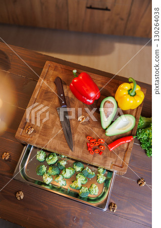 Close-up of fresh chopped vegetables on a wooden board, ready for healthy cooking 130264038