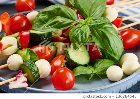 Vegetable platter with cucumber, tomato and cheese canapes Vegetable platter with cucumber, tomato and cheese canapes 130264543