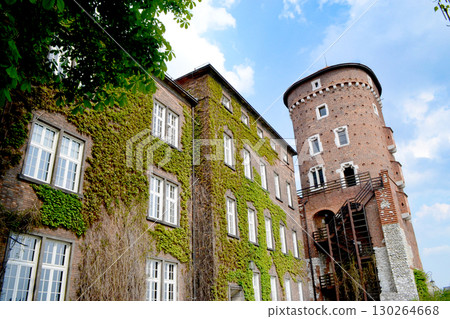Beautiful Krakow market square. Faded colors. Vintage elegant carriages with beautifully dressed horses ride people around the historic center of Krakow on the old streets of Europe High quality photo 130264668