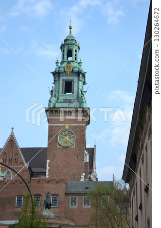 Beautiful Krakow market square. Faded colors. Vintage elegant carriages with beautifully dressed horses ride people around the historic center of Krakow on the old streets of Europe High quality photo 130264672