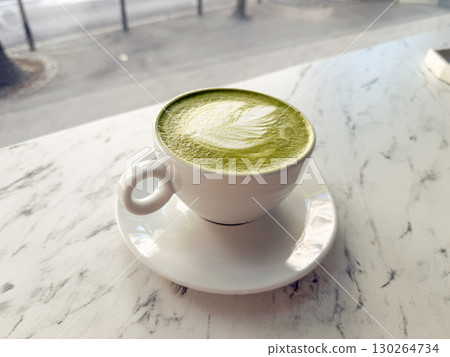 Top view of matcha latte with latte art on marble table. Wellness, organic beverage and cafe lifestyle 130264734