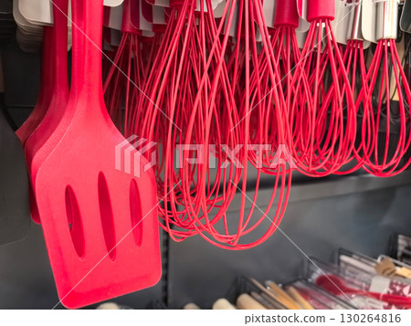 Bright red kitchen utensils arranged neatly on display in a cooking store Bright red kitchen utensils arranged neatly on display in a cooking store 130264816