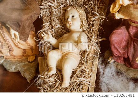 Baby Jesus laying in a cradle 130265491