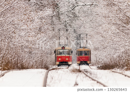 An old tram moving through a winter forest An old tram moving through a winter forest 130265643