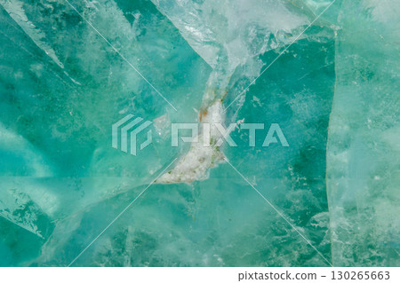 Macro mineral stone Fluorite crystal on a black background Macro mineral stone Fluorite crystal on a black background 130265663