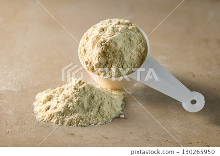 protein powder in scoop. dry mixture for preparation of sporting or dietary drink. protein powder in scoop. dry mixture for preparation of sporting or dietary drink. 130265950