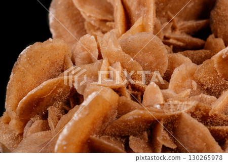 Macro mineral stone desert rose or sand rose on a black background Macro mineral stone desert rose or sand rose on a black background 130265978