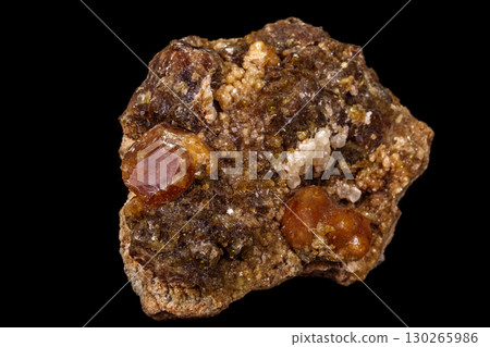 macro mineral stone Grossular, Garnet, Epidote on a black background 130265986