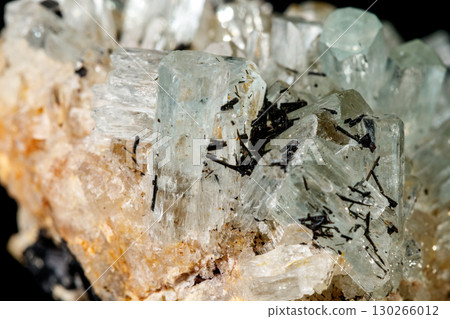 Macro mineral stone crystals Aquamarine in rock on a black background Macro mineral stone crystals Aquamarine in rock on a black background 130266012