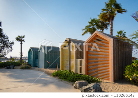 Bright colorful wooden houses on beach. Summer vacation at multicolored beach sheds huts. High quality photo 130266142
