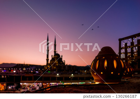 Panoramic top view of Al Sahab mosque and old town at sunset. Silhouettes of people in shopping area with souvenirs in shine of night lights, Sharm El Sheikh, Egypt. High quality photo 130266187