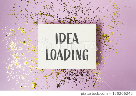 White sign with the word "idea" written on it is surrounded by gold glitter White sign with the word "idea" written on it is surrounded by gold glitter 130266243