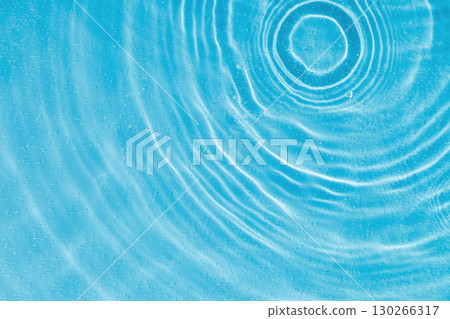 drops on water with circles on a blue background 130266317