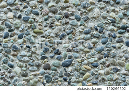 Close-up of a concrete wall with pebbles. Background/texture material Close-up of a concrete wall with pebbles. Background/texture material 130266802