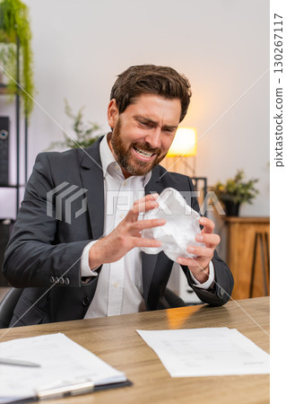 Middle-aged businessman manager crushes faulty report exhales hard calms and returns to edit again Middle-aged businessman manager crushes faulty report exhales hard calms and returns to edit again 130267117
