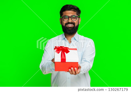 Indian man smiling offering gift birthday box kind gesture showing surprise happy giving present Indian man smiling offering gift birthday box kind gesture showing surprise happy giving present 130267179