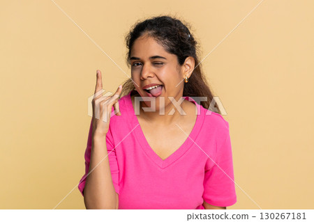 Indian woman making energetic rock-n-roll hand gesture, happily dancing like energetic rock star 130267181