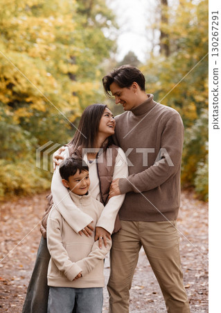 Happy Family Walking in Autumn Park 130267291