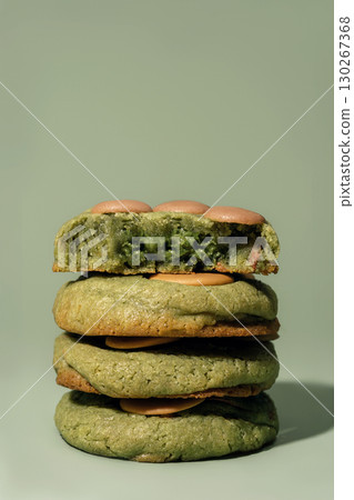 Pistachio cookies stacked with filling, showcasing vibrant green color and soft texture, ideal for bakery concept and menu design with copy space Pistachio cookies stacked with filling, showcasing vibrant green color and soft texture, ideal for bakery concept and menu design with copy space 130267368