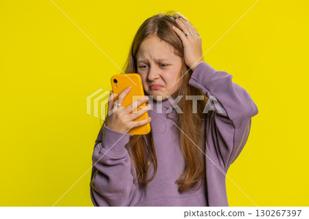 Upset sad child girl use smartphone play game loses loss fail unlucky news bad lottery result crisis Upset sad child girl use smartphone play game loses loss fail unlucky news bad lottery result crisis 130267397