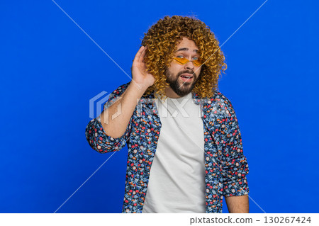 Caucasian man trying hear you looking confused and frowning, keeping arm near ear for louder voice Caucasian man trying hear you looking confused and frowning, keeping arm near ear for louder voice 130267424