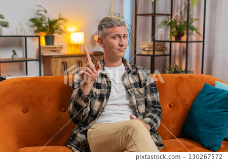 Displeased upset man reacting to unpleasant awful idea, dismiss bad idea, wave hand, shake head No 130267572