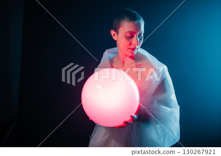 A Pink Light Ball In The Hand Of A Short Haired Woman A Pink Light Ball In The Hand Of A Short Haired Woman 130267921