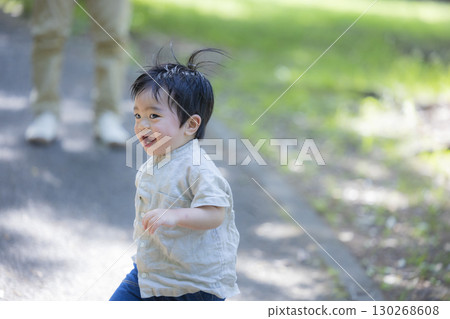 A boy playing in a park 130268608