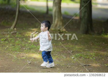 A boy playing in a park 130268612