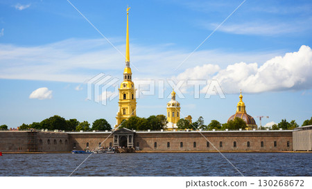 Peter and Paul Cathedral and fortress in Saint Petersburg, Russia. Scenery of historical landmark of city with Neva river and blue sky Peter and Paul Cathedral and fortress in Saint Petersburg, Russia. Scenery of historical landmark of city with Neva river and blue sky 130268672