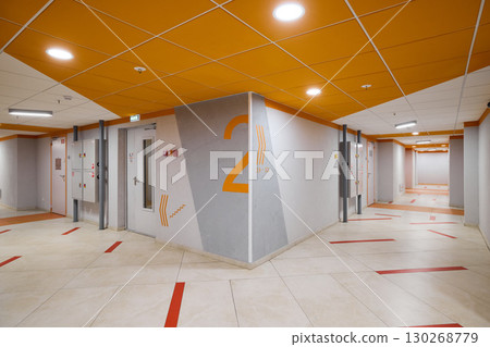 Explore the essence of modern corridor design while incorporating vibrant orange accents Explore the essence of modern corridor design while incorporating vibrant orange accents 130268779