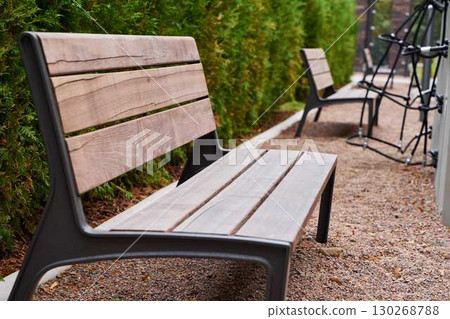 Modern Outdoor Benches Placed Comfortably Amidst Lush Greenery and Beautiful Landscapes Modern Outdoor Benches Placed Comfortably Amidst Lush Greenery and Beautiful Landscapes 130268788