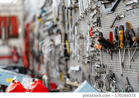 Various hand tools organized on pegboard in 130269378