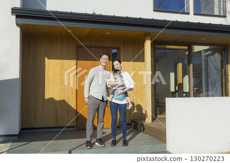 A family standing in front of a family 130270223
