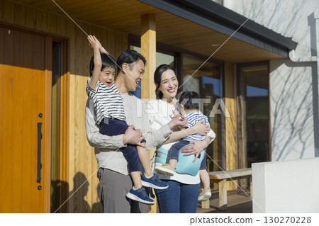 A family standing in front of a family A family standing in front of a family 130270228