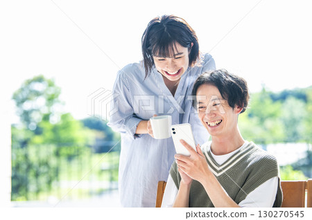 A couple searching on a smartphone 130270545