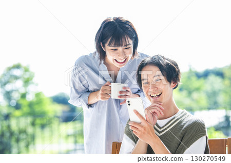 A couple searching on a smartphone 130270549