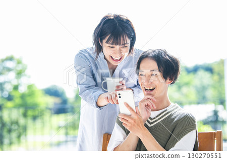 A couple searching on a smartphone 130270551