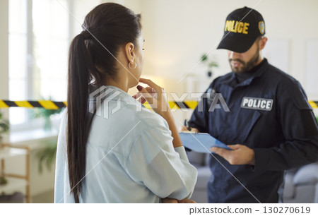 Police Officer Or Detective Investigating Crime Scene With Victim Police Officer Or Detective Investigating Crime Scene With Victim 130270619