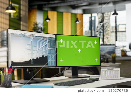 Isolated screen PC in empty engineering office used to refine transmission tower systems, improving clean energy integration. Chroma key computer in workspace used to design power lines infrastructure 130270786