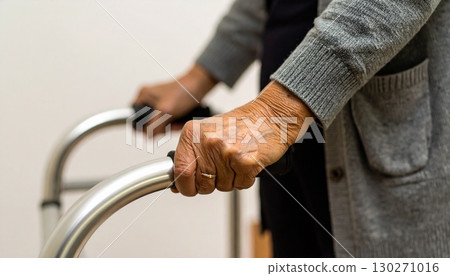 Senior woman holding onto the handrail and climbing the stairs Senior woman holding onto the handrail and climbing the stairs 130271016
