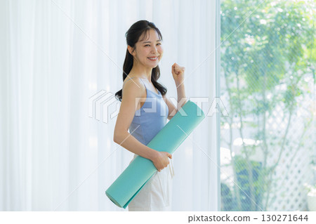 Woman doing yoga in the living room 130271644