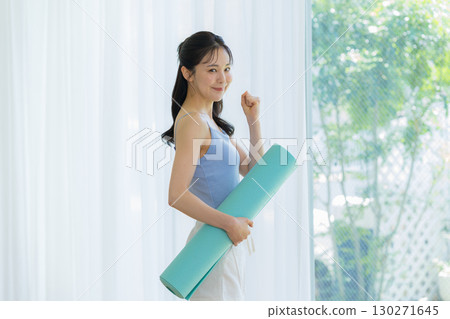 Woman doing yoga in the living room Woman doing yoga in the living room 130271645