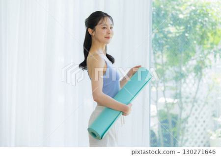 Woman doing yoga in the living room 130271646