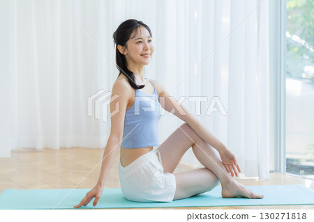 Woman doing yoga in the living room 130271818