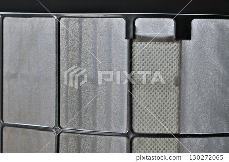 A thin layer of dust on the air conditioner filter A thin layer of dust on the air conditioner filter 130272065