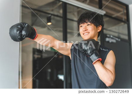 Gym, young Asian man doing boxing exercises at training gym 130272649