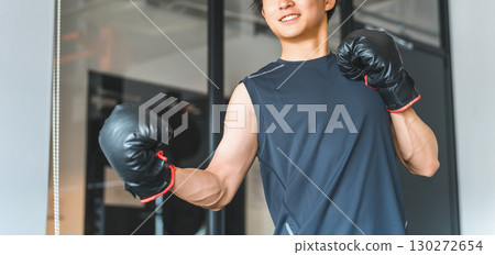 Gym, young Asian man doing boxing exercises at training gym 130272654