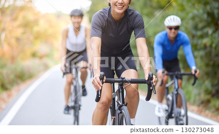 Men and women cycling on road bikes 130273048