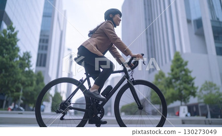 Woman cycling on a road bike 130273049